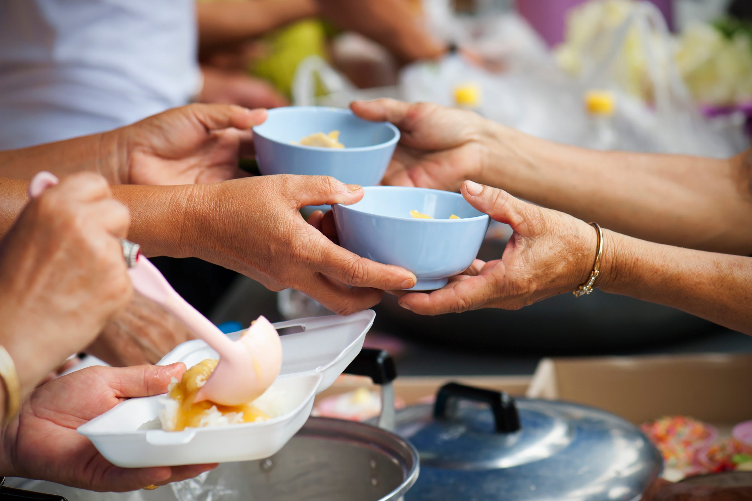 Rich people give food to the poor. starvation concept